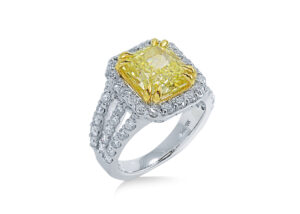 A 14K white gold & diamond ring with a yellow gemstone.